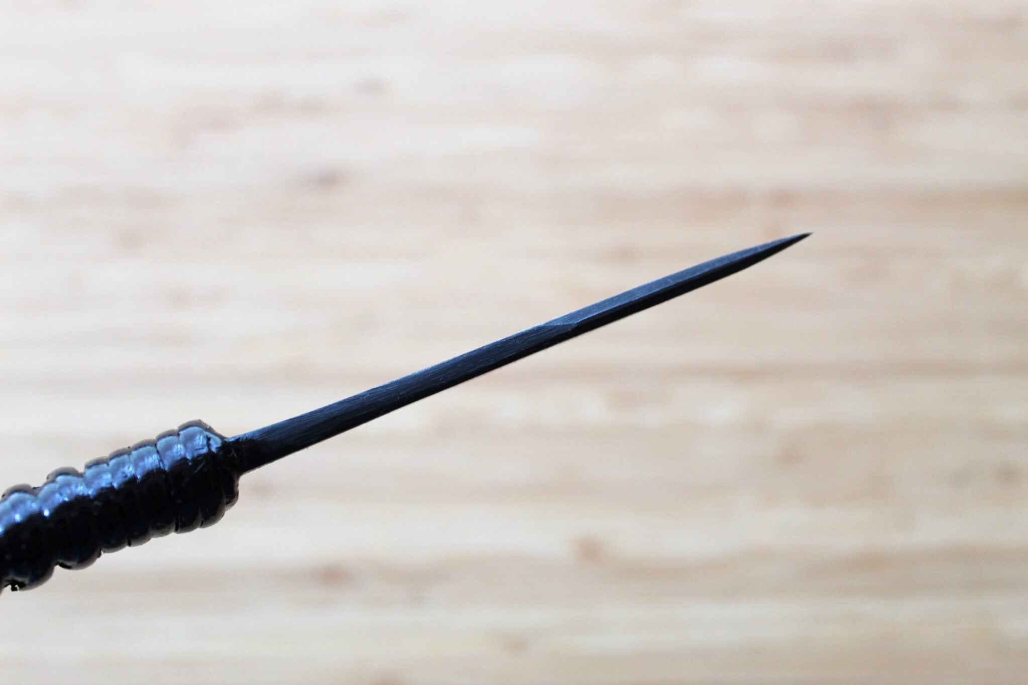Side view of 85mm Japanese paring knife with 3mm thick spine and Kurouchi finish