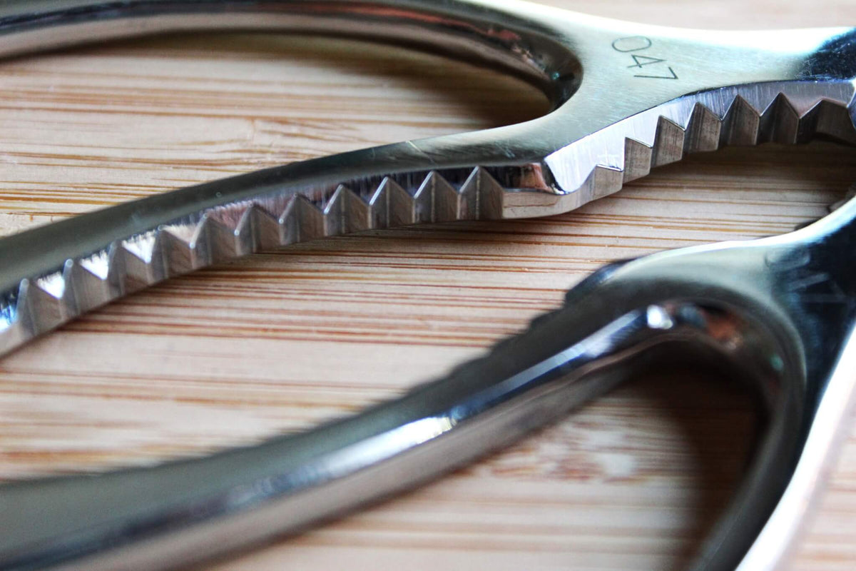 Zuiko 190mm all-stainless steel Japanese kitchen shears closed, showing one-piece metal handles and Sakai cutlery