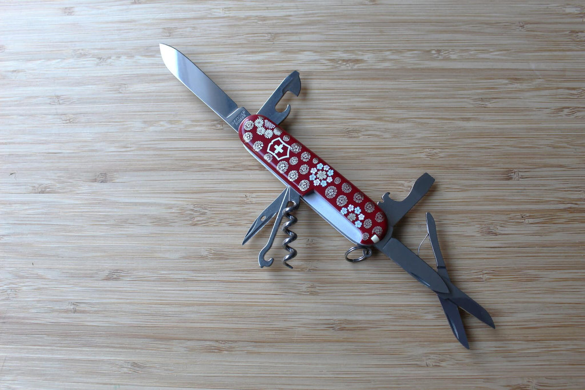 Victorinox Climber 91mm Swiss Army Knife fully opened with all 14 stainless steel tools displayed, including large blade, small blade, scissors, and corkscrew