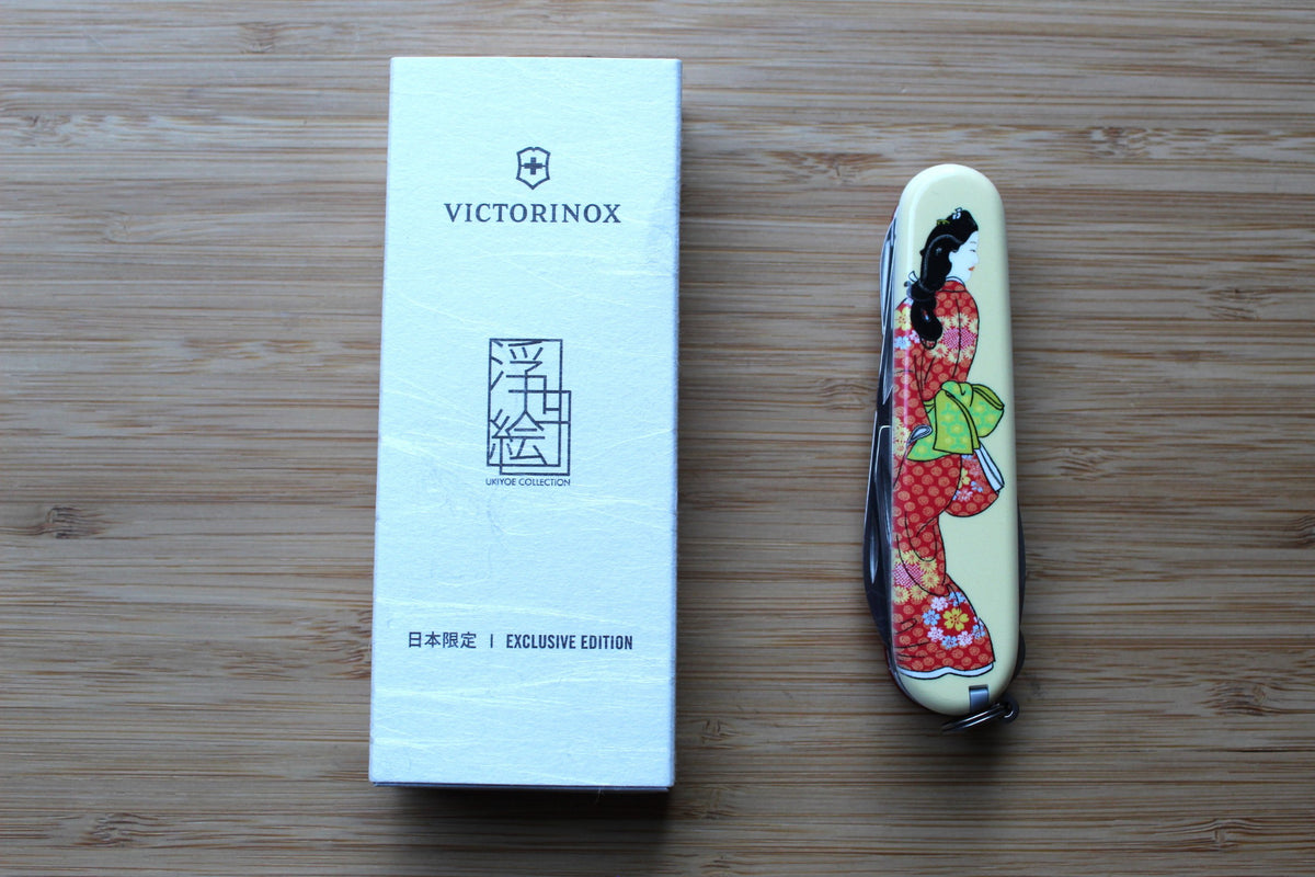 Victorinox Climber 91mm Swiss Army Knife closed, showing Japanese Ukiyo-e Mikaeri Bijin-zu artwork depicting a classical woman looking over her shoulder by box.