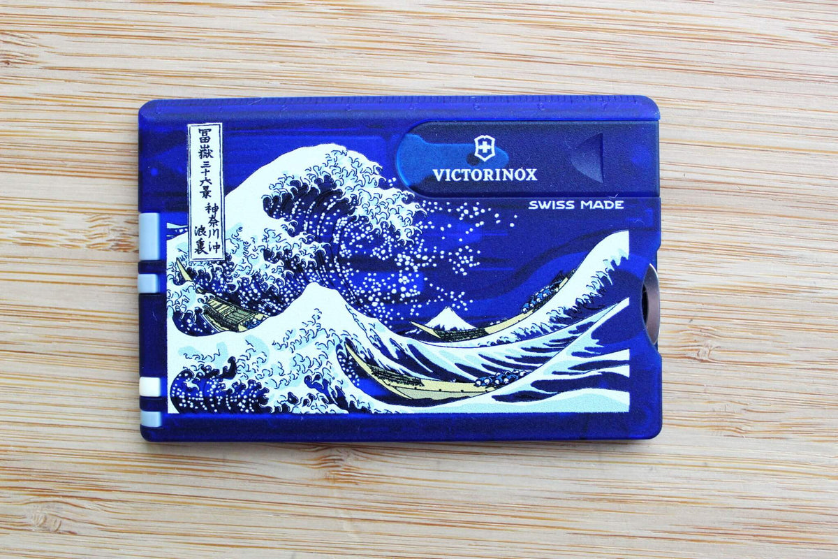 Victorinox Swiss Card Classic showing Katsushika Hokusai's The Great Wave off Kanagawa woodblock print with indigo blue tones