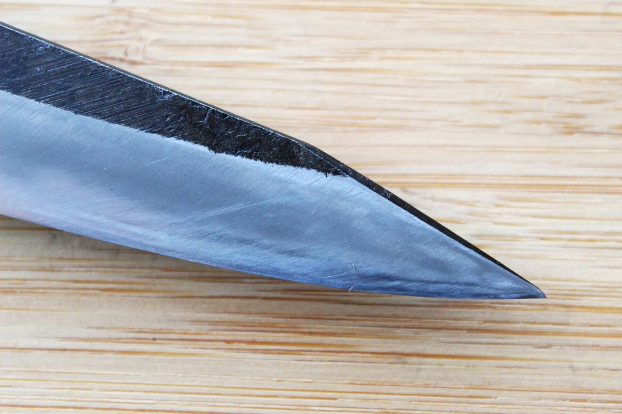 Detail of Shirogami #2 core and Kurouchi finish on a heavy-duty Japanese paring knife