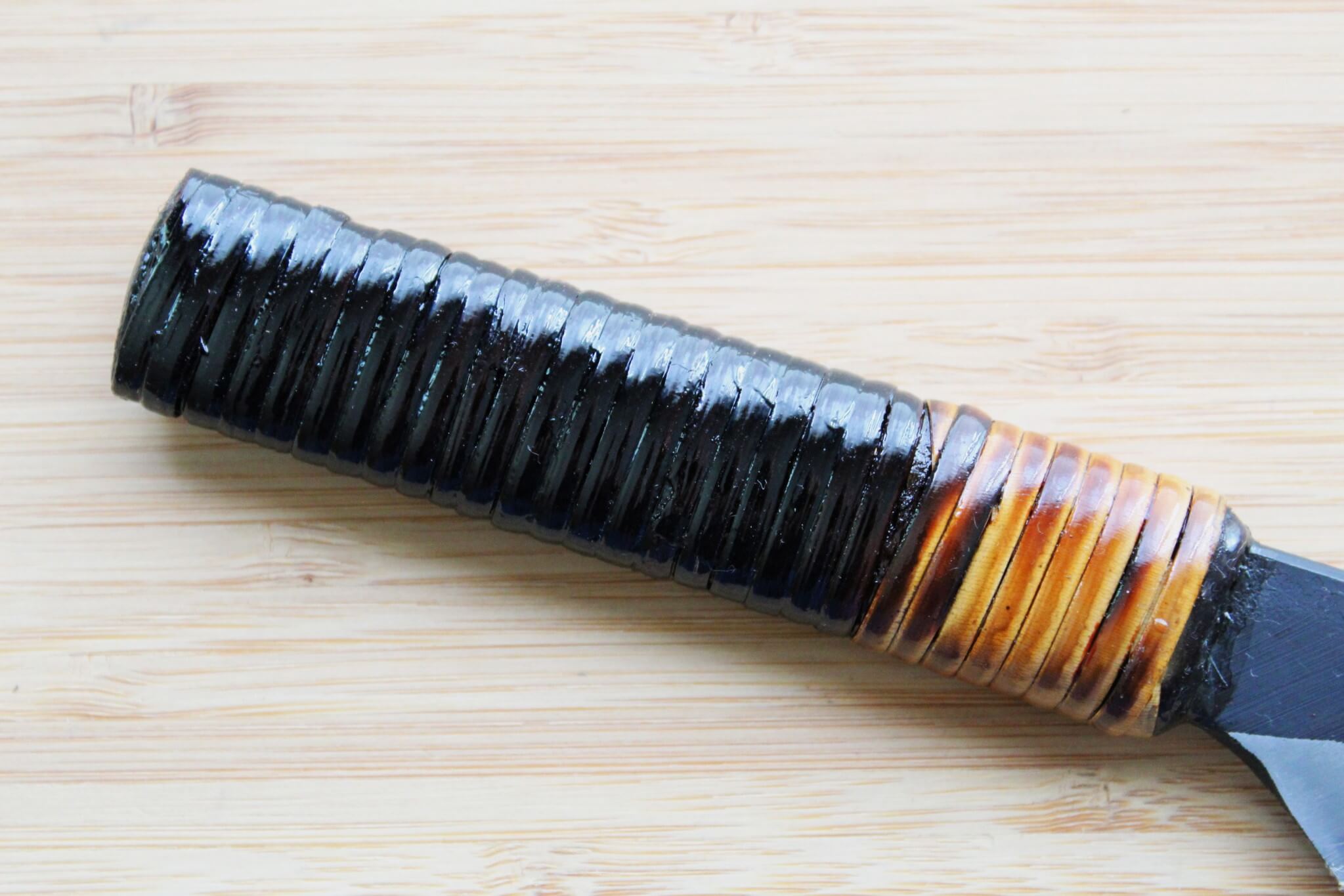 Detail of traditional Fujimaki rattan-wrapped full-tang handle on a Kyoto-forged knife