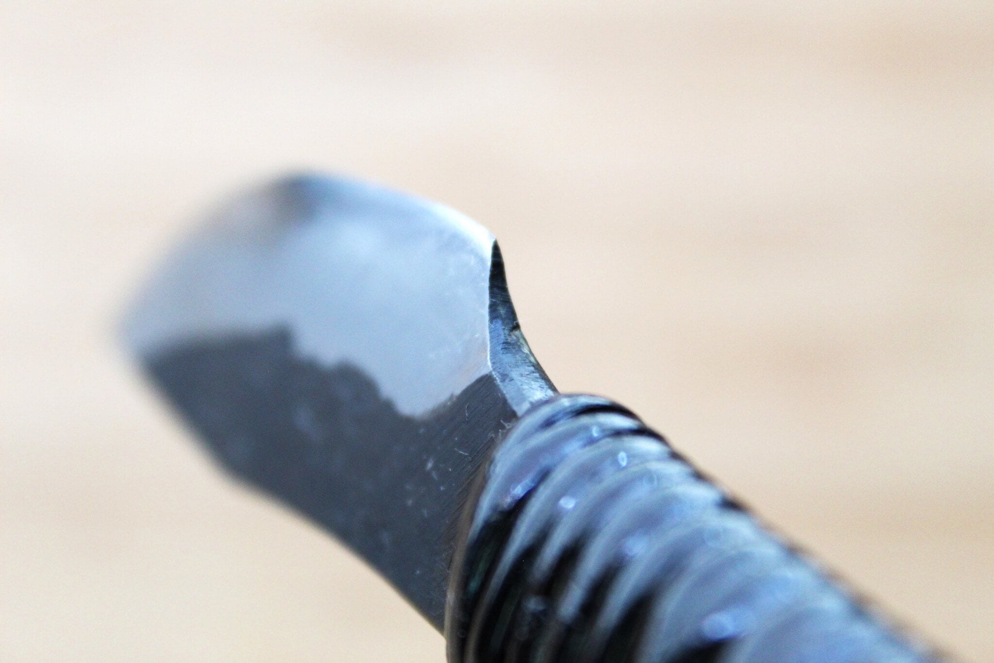 Side view of 85mm Japanese paring knife with 3mm thick spine and Kurouchi finish