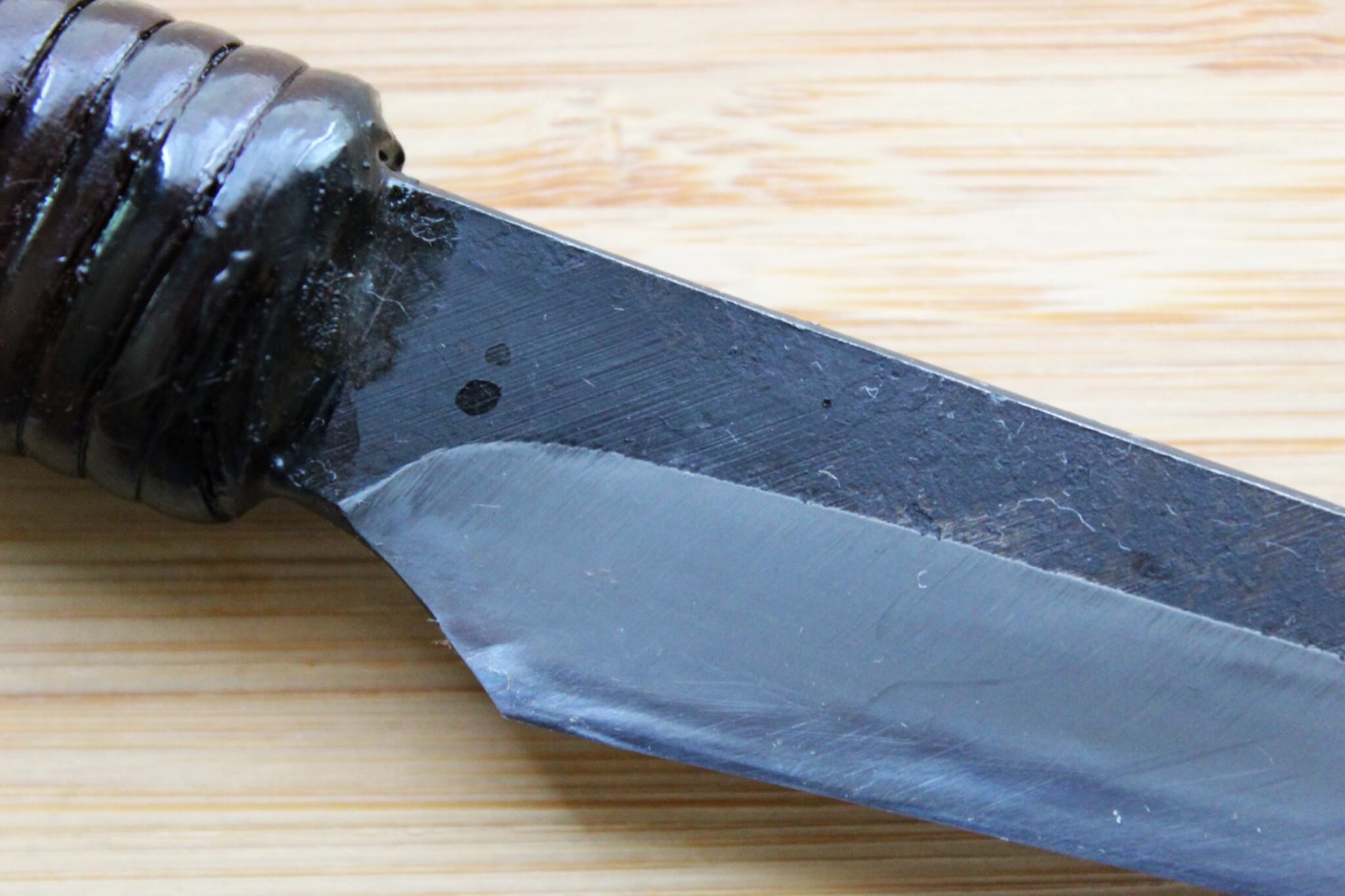 Detail of Shirogami #2 core and Kurouchi finish on a heavy-duty Japanese paring knife