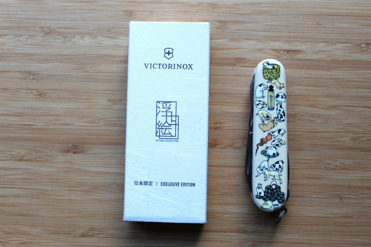 Victorinox Climber 91mm Swiss Army Knife closed, showing Japanese Ukiyo-e Neko-Zukushi artwork with traditional cat illustrations on Cellidor scales by box.